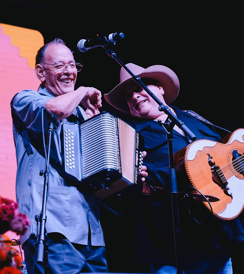 Accordionist performing live on stage during the Flaco Jiménez Tribute at Muertos Fes